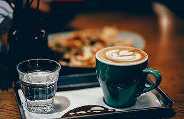 A cup of coffee with a serene background